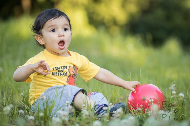 Kid with red ball in forest